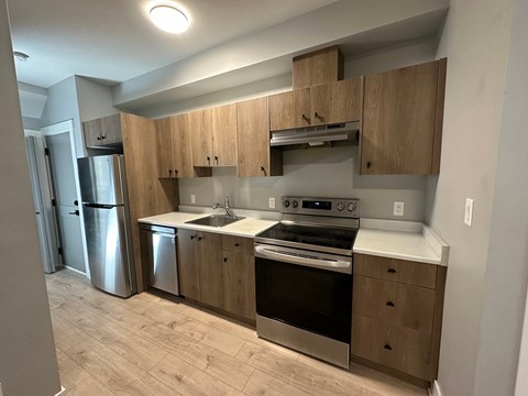 A kitchen with wooden cabinets and stainless steel appliances.