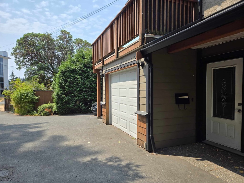A house with a white door and a garage door.