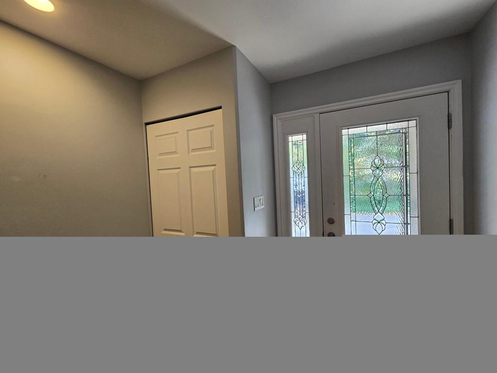 A white door with a window above it.