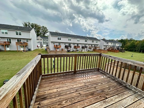 a large deck with a view of an apartment building