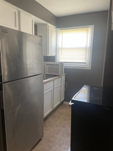 a kitchen with stainless steel appliances and a window