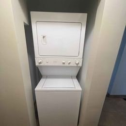 A white toilet with a closed lid and a closed seat.