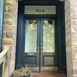 The front door of a building with the number 514 on it.