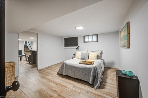 A bedroom with a bed, a chair, and a television.