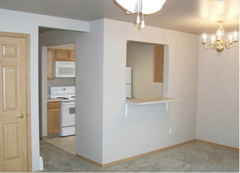 A kitchen area with a stove, oven, and microwave.