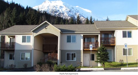 Apartment complex with a mountain in the background.