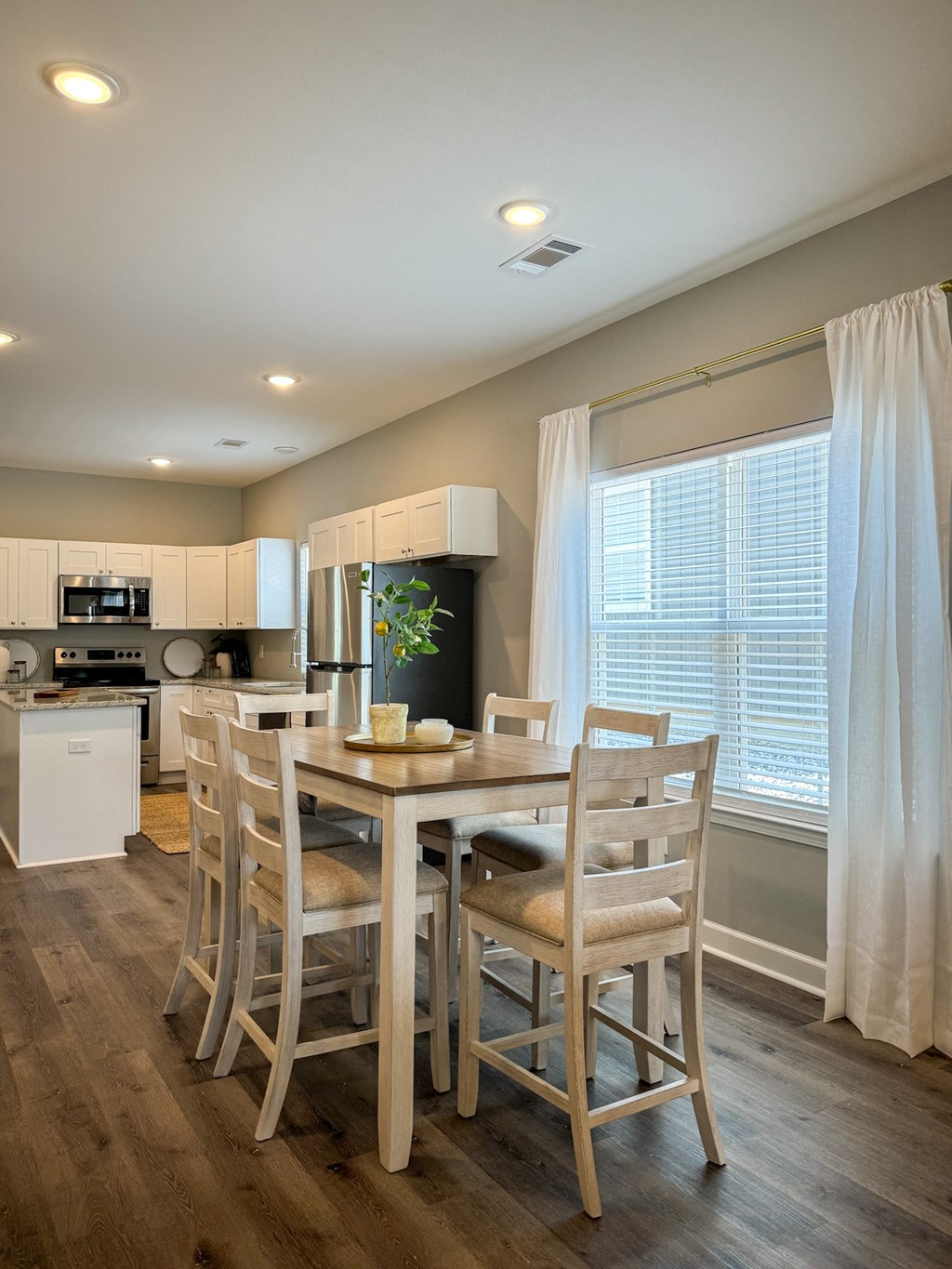 a dining room with a table and chairs in a kitchen