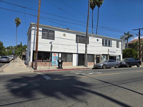 a white building on the corner of a street