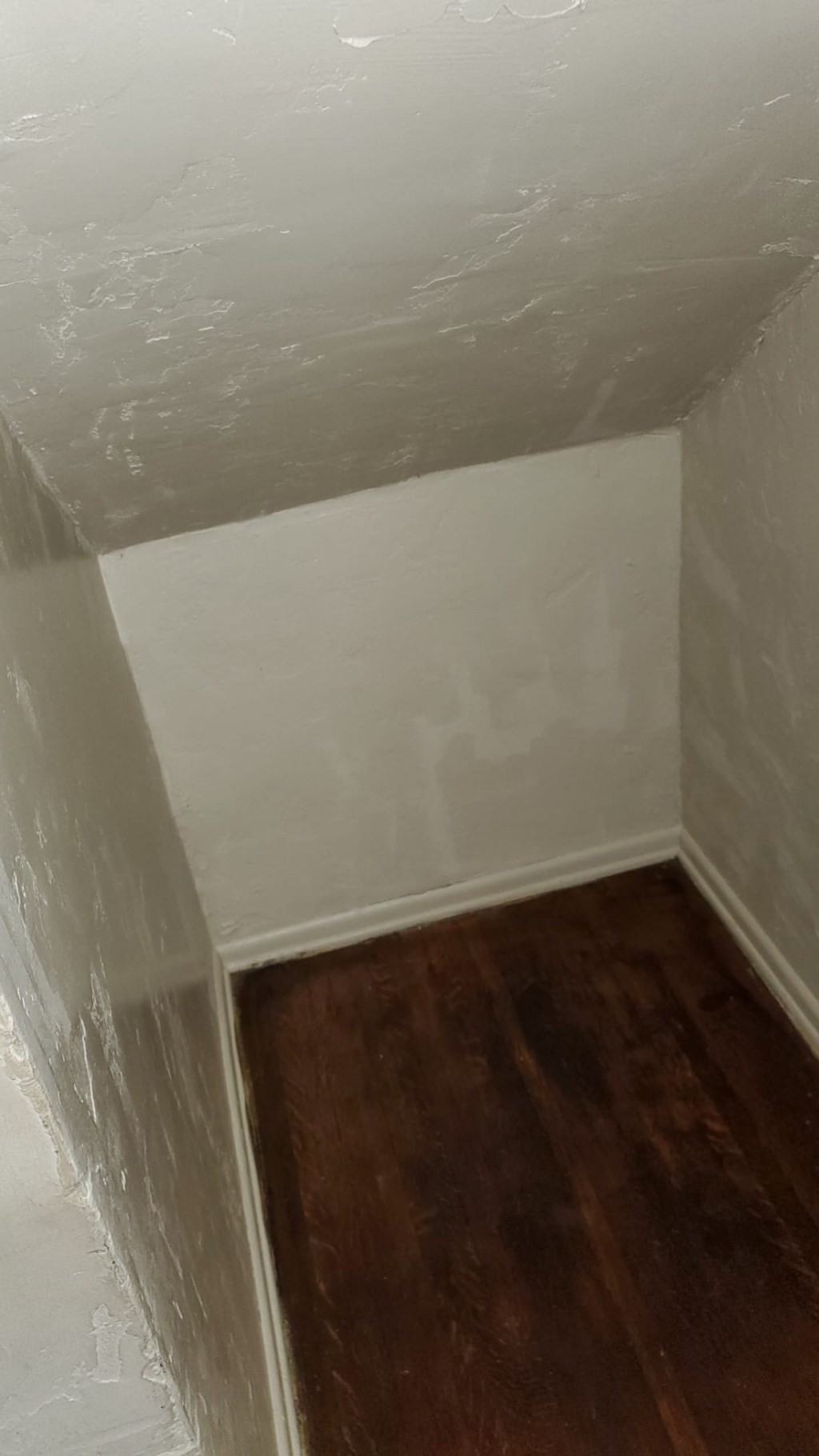 A room with wooden floors and white walls.