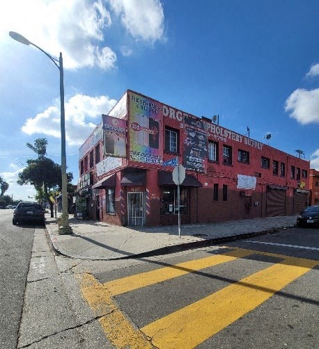 A red building with a sign that says "DRUNKEN SCHOOL BOARD" on it.