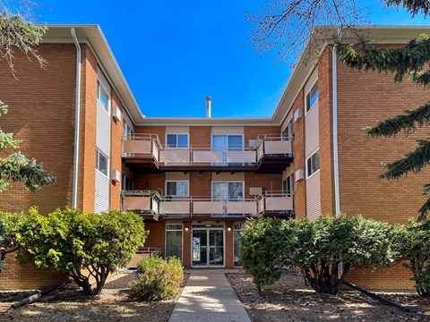 A multi-story apartment building with a courtyard in the middle.