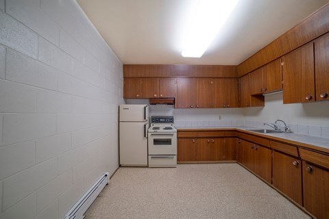 a kitchen with white appliances and wooden cabinets