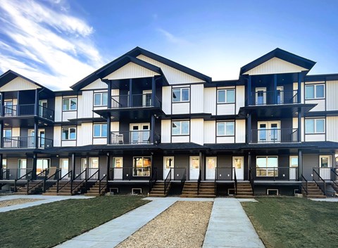 A modern apartment complex with black and white balconies.