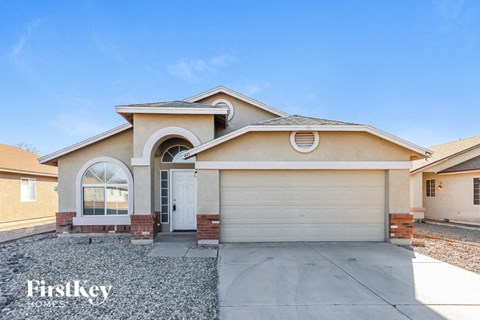 a beige house with a white garage door