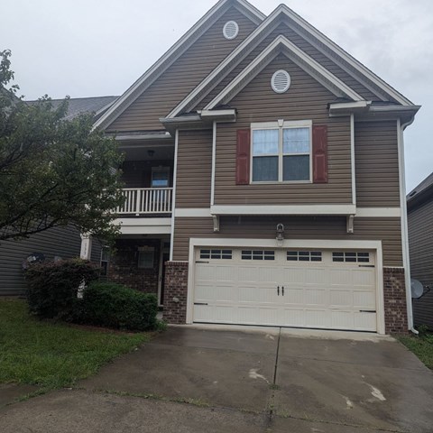 a brown house with a white garage door