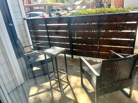 a patio with two chairs and a table on it