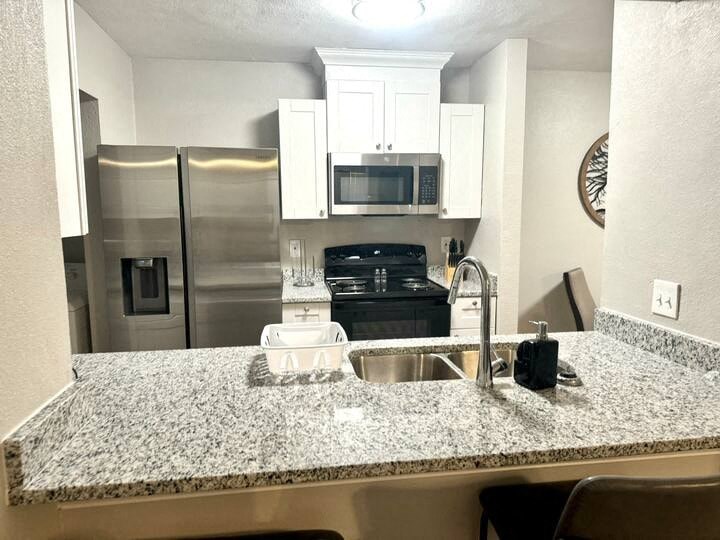 a kitchen with a granite counter top and a sink