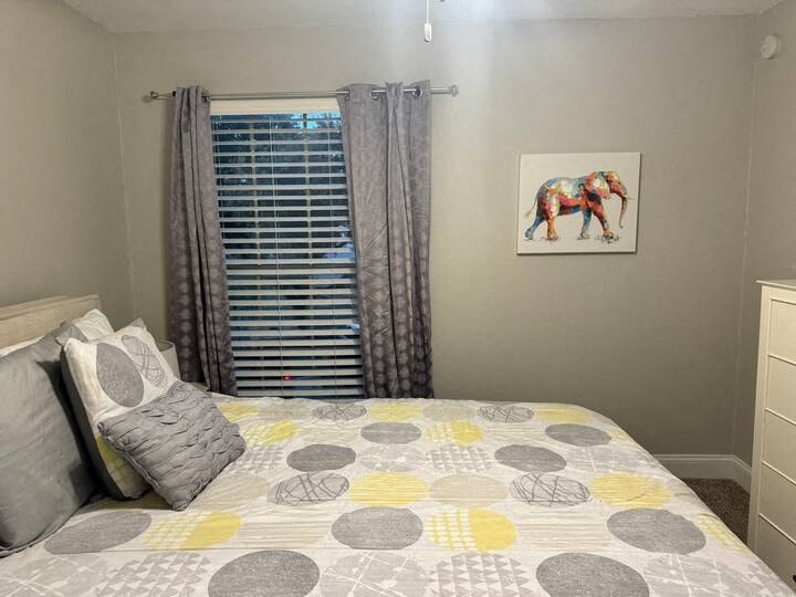 a bedroom with a bed and a picture of an elephant