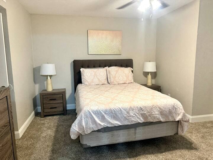 a bedroom with a bed and two lamps