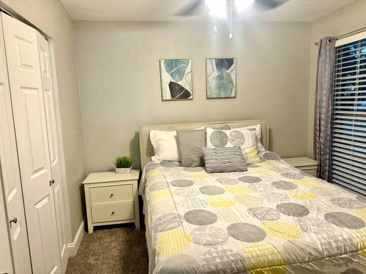 a bedroom with a bed and some pictures on the wall