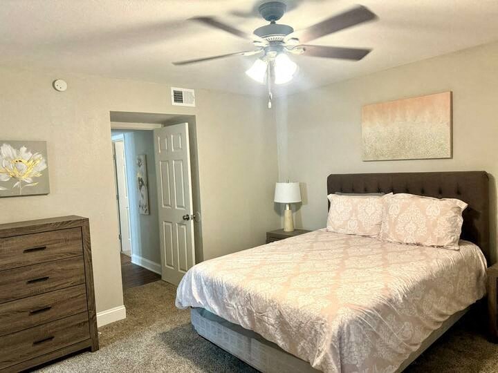 a bedroom with a bed and a ceiling fan