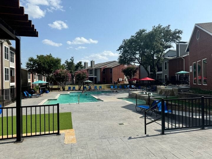 a swimming pool with chairs and umbrellas