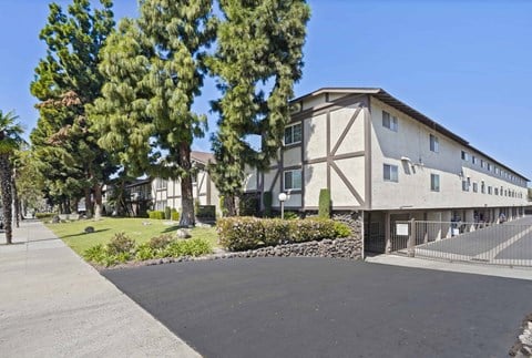 A large building with a driveway in front of it.