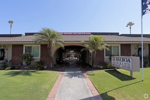 The entrance to a building with a sign that reads "The Balboa Apartments".