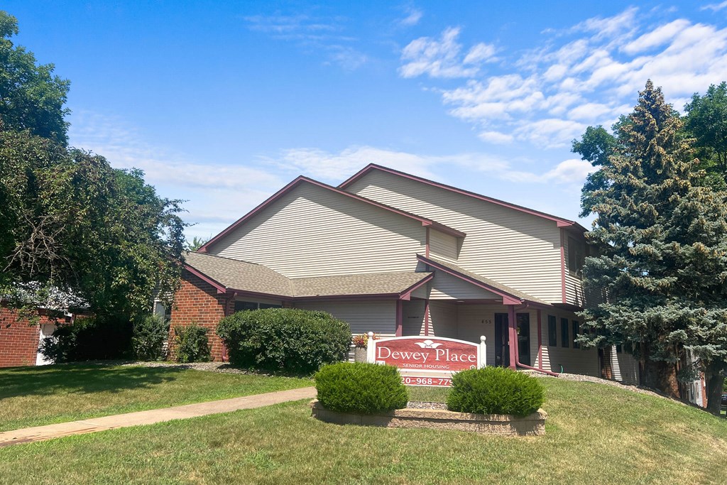 A house with a red sign that says Dewey Place.