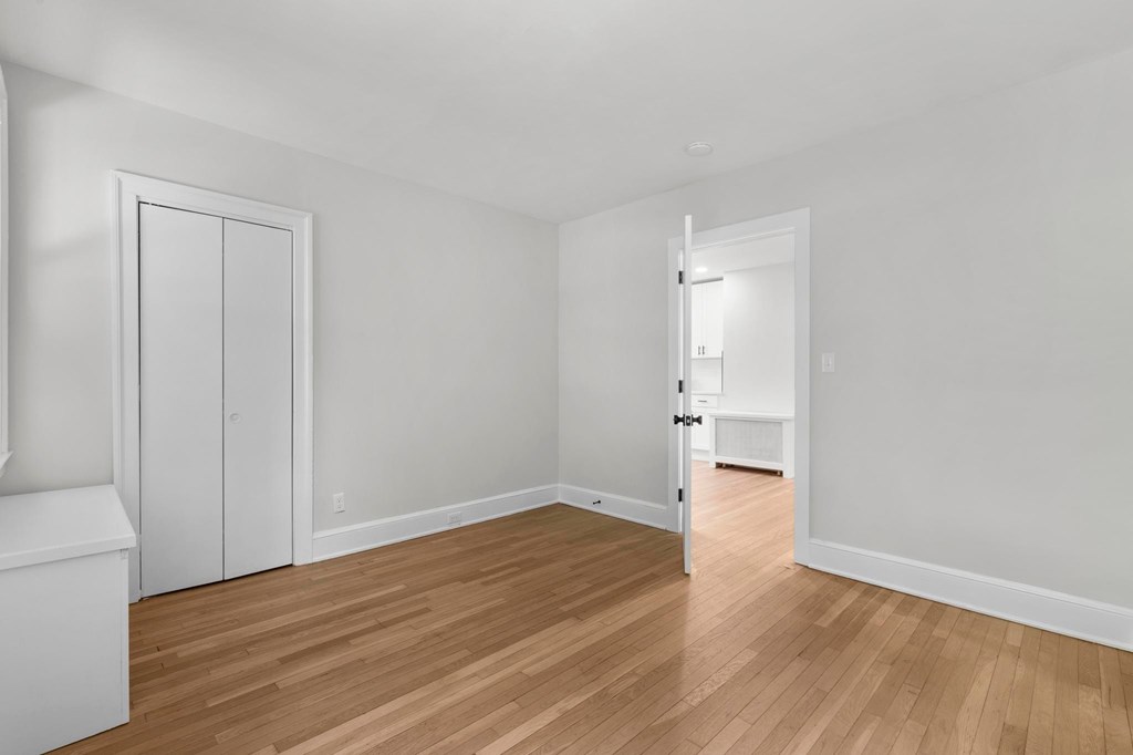 A room with a wooden floor and white walls.