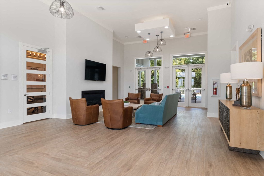 a living room with a couch and chairs and a fireplace