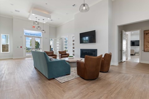 a living room with a couch and chairs and a fireplace