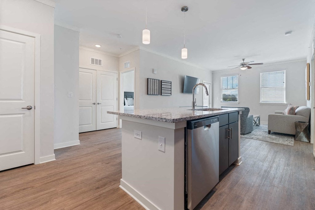 a kitchen with an island and a living room