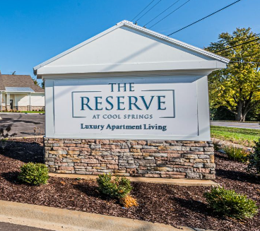 the reserve at cool springs sign on the side of the street
