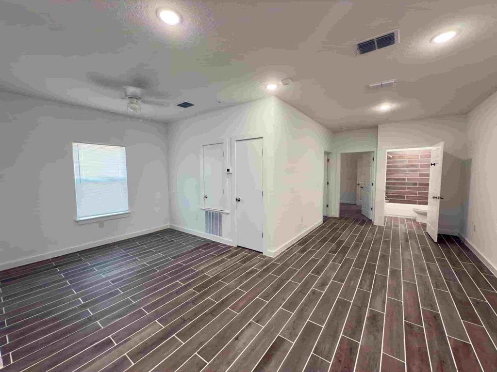 an empty room with tile floors and white walls