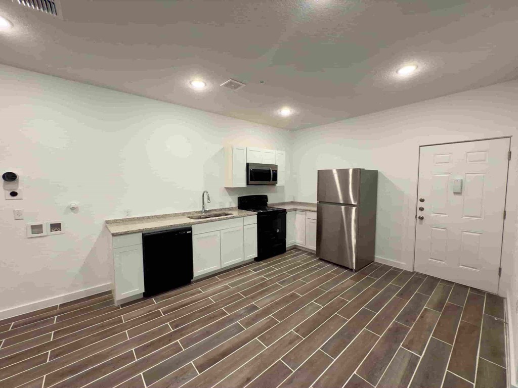 a kitchen with a refrigerator and a sink and a refrigerator