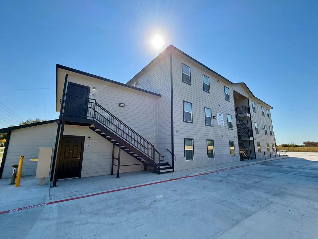 the front of a building with the sun shining on it