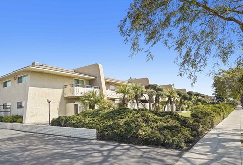 A row of houses with a clear blue sky above them.