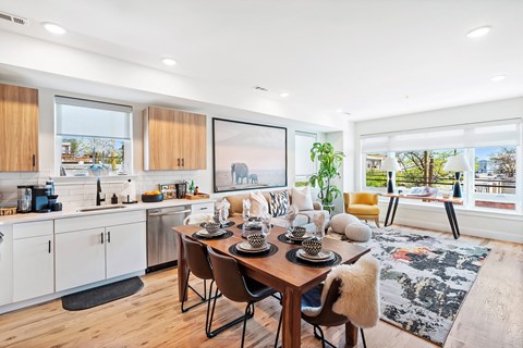A modern kitchen with a dining table set for four.