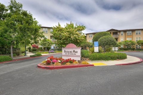 A sign that says Vista Del Mar in front of a building.