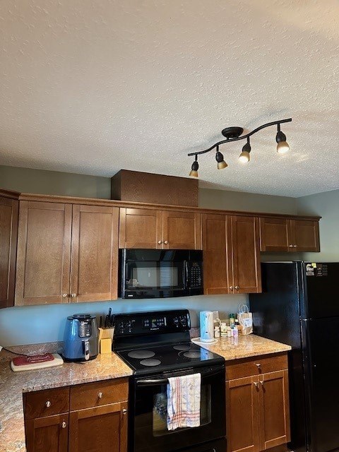 A kitchen with wooden cabinets and black appliances.