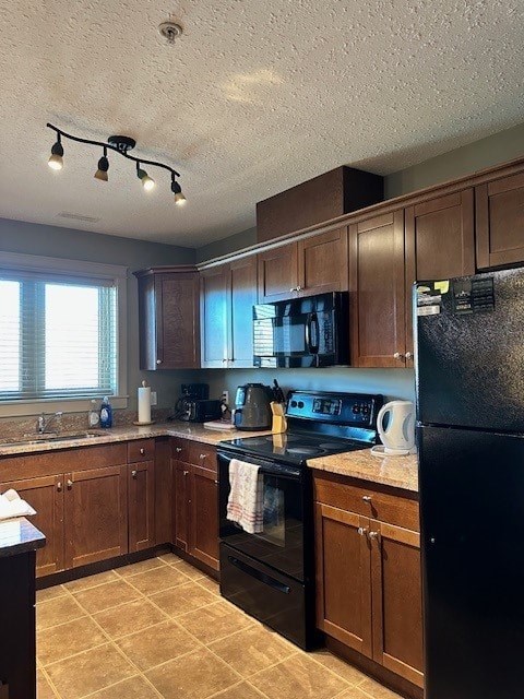 A kitchen with black appliances and wooden cabinets.