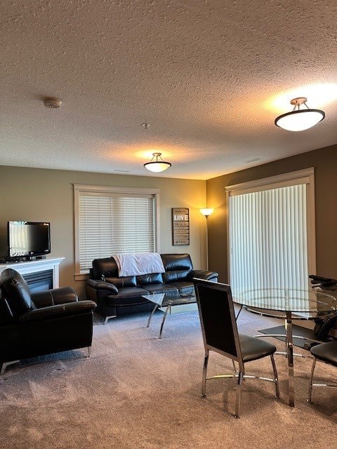 A living room with a fireplace, a couch, a chair, and a television.