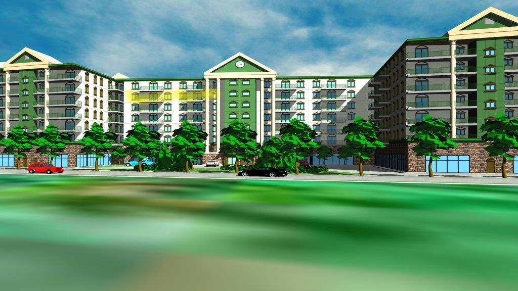 A row of apartment buildings with green trees in front.
