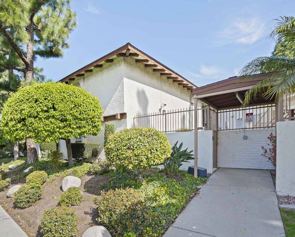 A house with a white garage door and a white fence.
