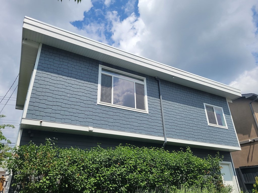 A house with a grey roof and a window.