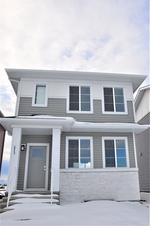A house with a grey front and a grey door.