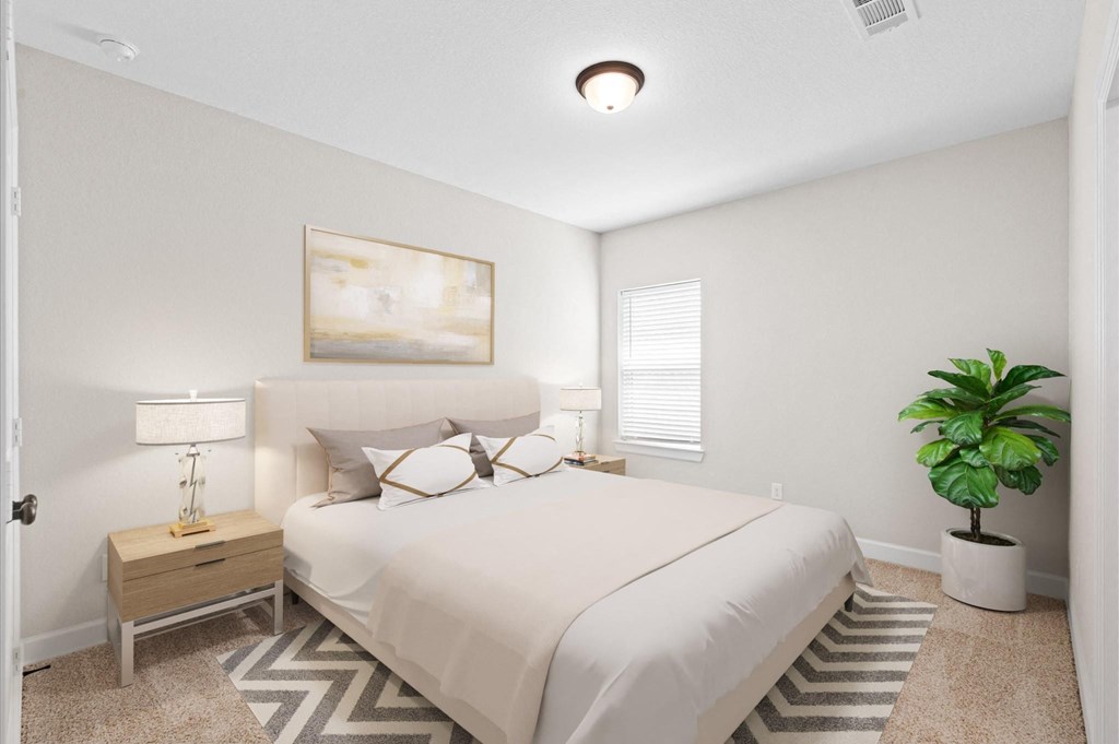 A bedroom with a large bed and a painting on the wall.