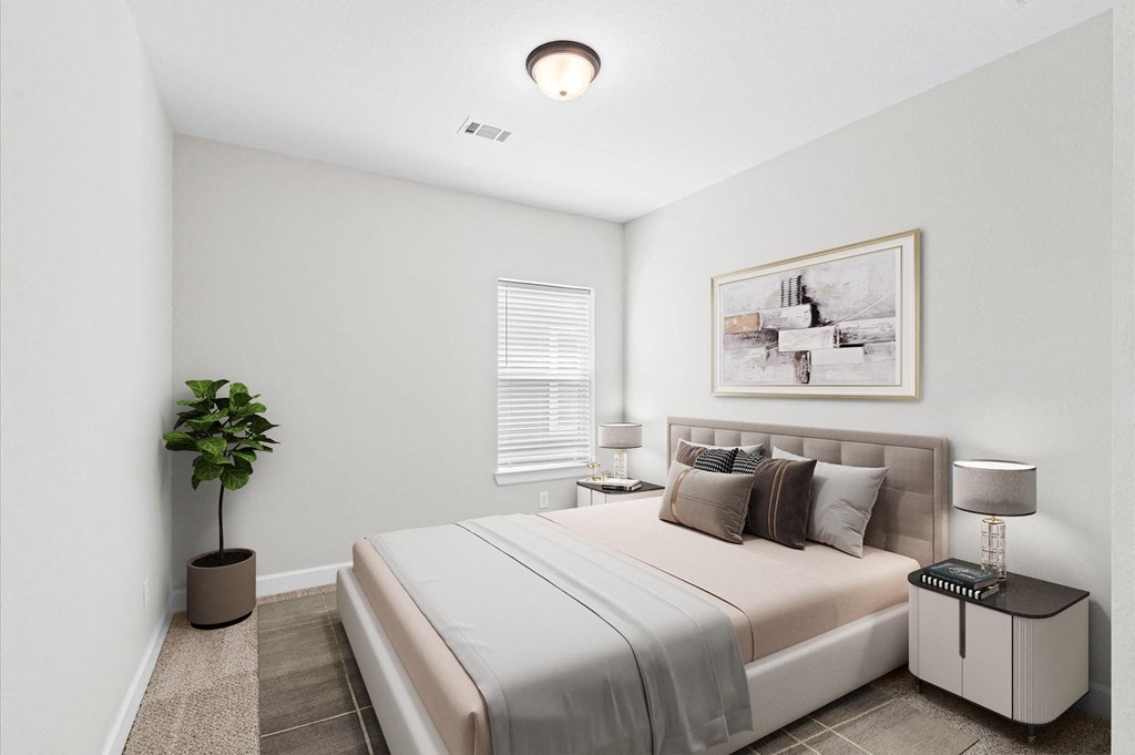 A bedroom with a bed, nightstand, and a plant.