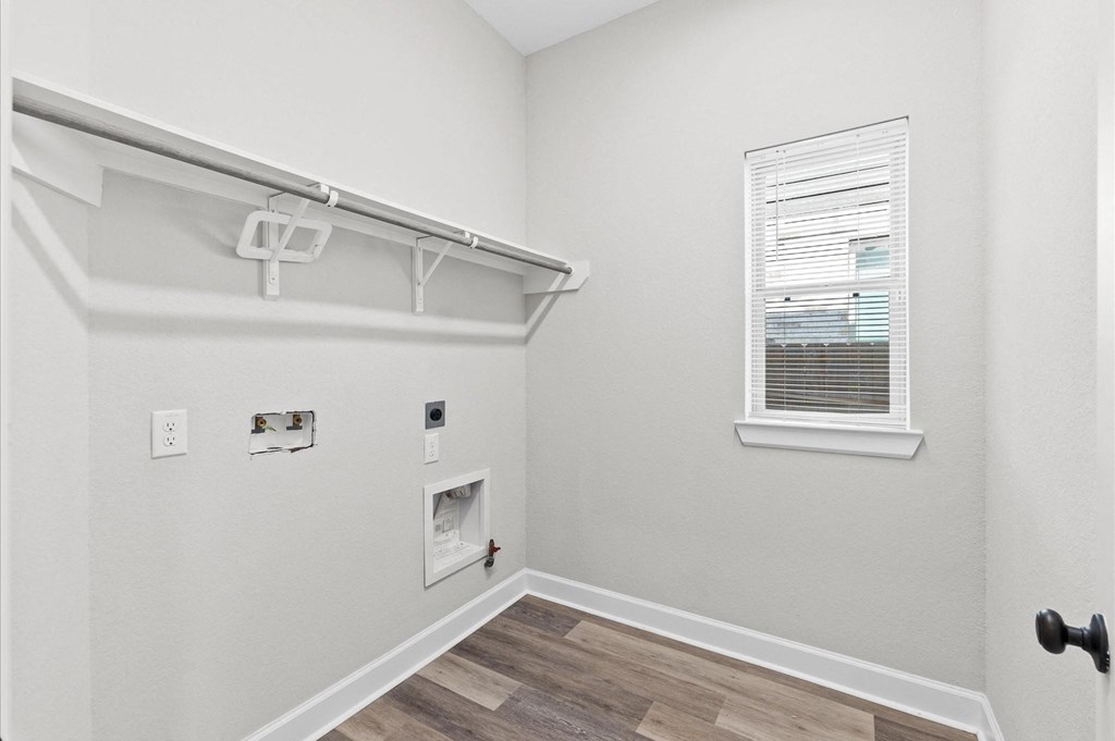 A white wall with a shelf and a window.